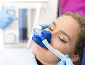 Woman in dental chair with nitrous oxide nose mask