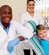 Dentist assistant and young boy in dental office