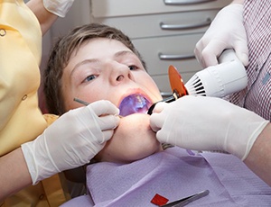 young man getting tooth-colored filling 