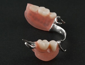 partial dentures against a black background