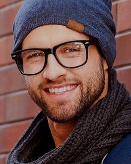 Smiling young man with facial hair and beanie