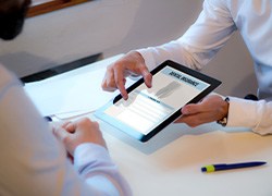 Patient reviewing dental insurance form on tablet