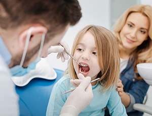 Little girl having her teeth checked