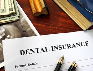 Image of an impacted wisdom tooth
Dental insurance form on a table
