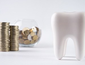 Pile of money next to a tooth